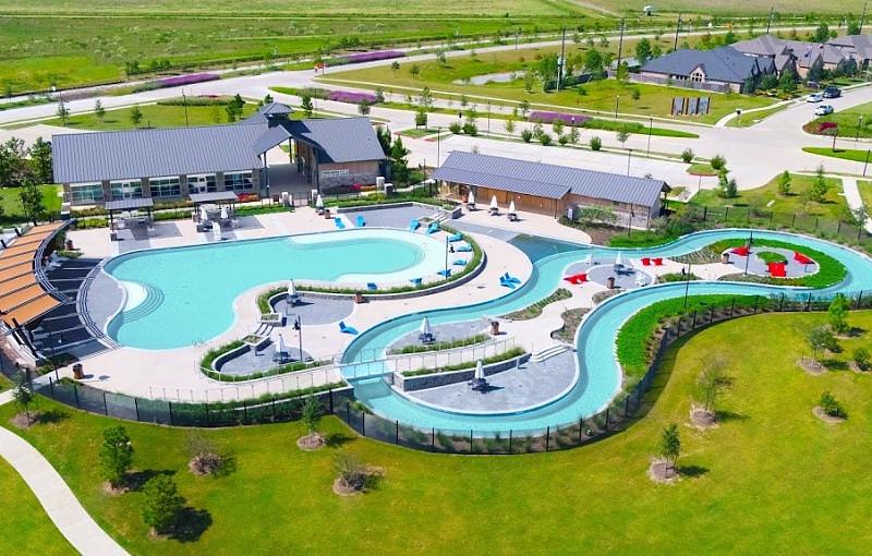 Aerial view of the resort-style pool and lazy river at The Shed in Jordan Ranch Fulshear