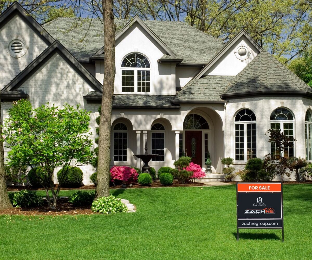 For sale sign in front of a landscaped two story home, selling a house in Fort Bend County TX