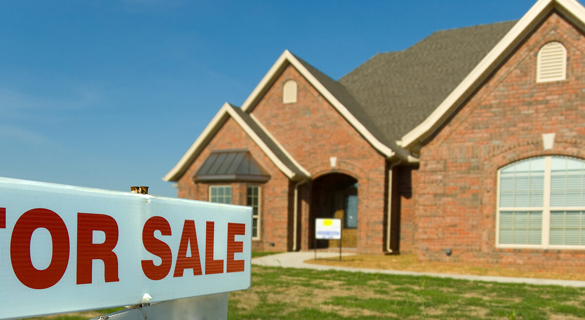 For sale sign in front of a brick home, selling a house in Fort Bend County TX